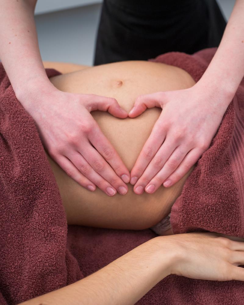 massage on the belly of pregnant woman